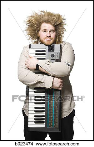 man holding a keyboard View Large Photo Image Picture - man holding a keyboard. Fotosearch