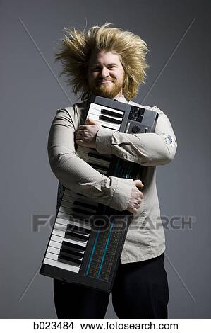 man holding a keyboard View Large Photo Image Picture - man holding a keyboard. Fotosearch