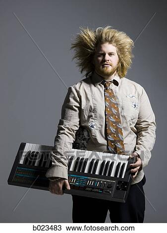 man holding a keyboard View Large Photo Image Stock Image - man holding a keyboard. Fotosearch