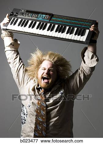 man holding a keyboard View Large Photo Image Stock Photo - man holding a keyboard. Fotosearch