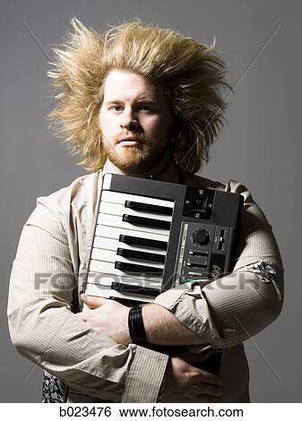 man holding a keyboard View Large Photo Image Stock Photograph - man holding a keyboard. Fotosearch