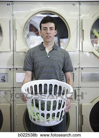 man holding a laundry basket View Large Photo Image Stock Image - man holding a laundry basket. Fotosearch