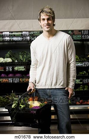 Stock Photo - man holding a shopping basket. Fotosearch