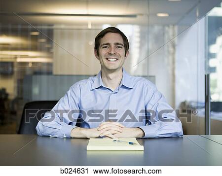 Stock Image - man in a blue shirt at work. Fotosearch