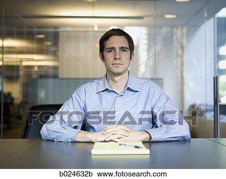 Stock Image - man in a blue shirt at work. Fotosearch