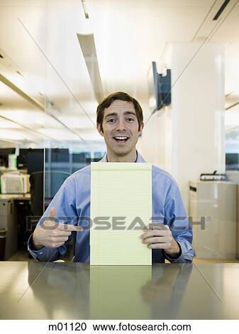 Stock Image - man in a blue shirt at work. Fotosearch