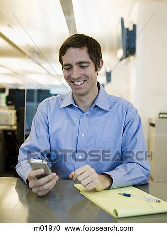 Stock Image - man in a blue shirt at work. Fotosearch