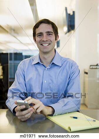 Stock Image - man in a blue shirt at work. Fotosearch