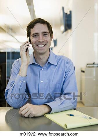 Stock Image - man in a blue shirt at work. Fotosearch