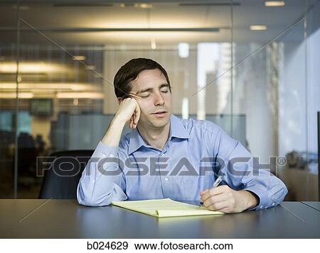 Stock Photo - man in a blue shirt at work. Fotosearch
