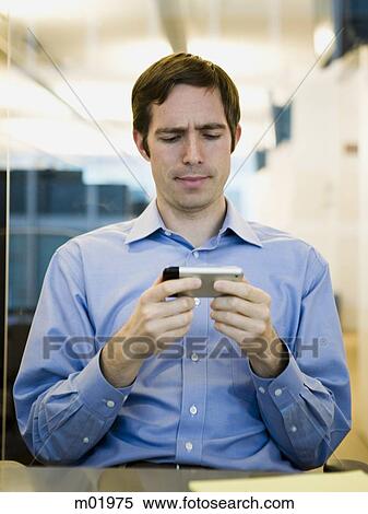 Stock Photography - man in a blue shirt at work. Fotosearch