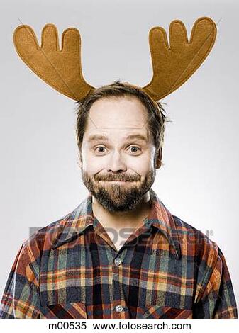 man in a plaid shirt wearing antlers View Large Photo Image Stock Photography - man in a plaid shirt wearing antlers. Fotosearch