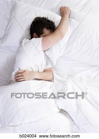 Picture - man in bed. Fotosearch