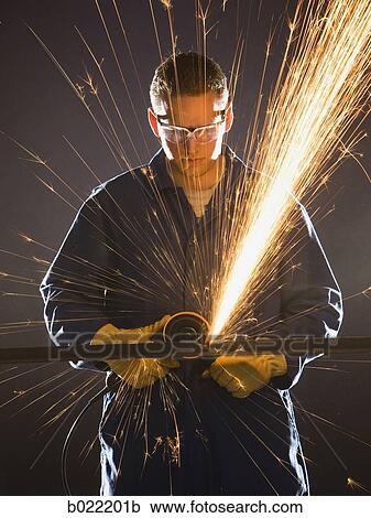 man in blue coveralls with a power grinder View Large Photo Image Stock Image - man in blue coveralls with a power grinder. Fotosearch