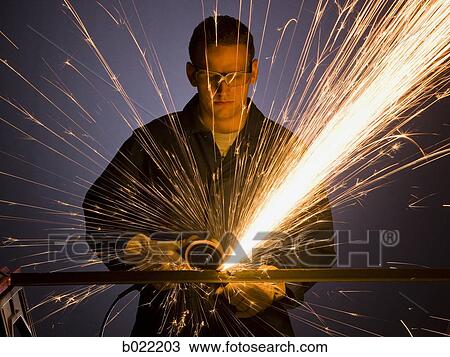 man in blue coveralls with a power grinder View Large Photo Image Stock Image - man in blue coveralls with a power grinder. Fotosearch