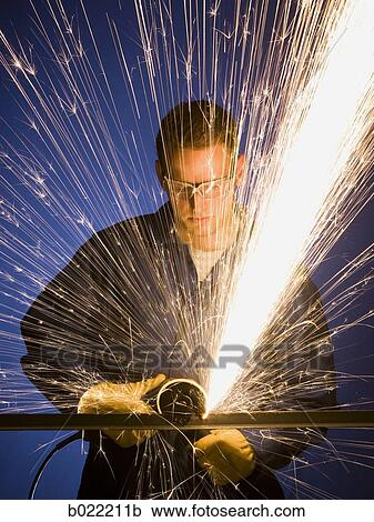 man in blue coveralls with a power grinder View Large Photo Image Stock Image - man in blue coveralls with a power grinder. Fotosearch