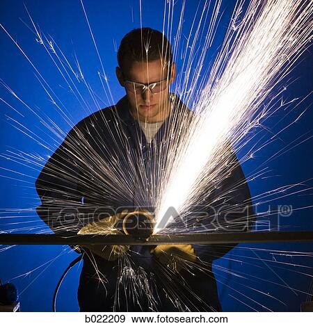 man in blue coveralls with a power grinder View Large Photo Image Stock Photo - man in blue coveralls with a power grinder. Fotosearch