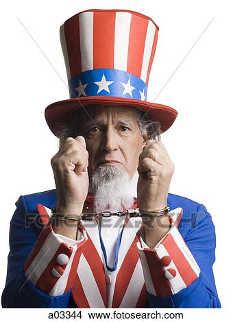 Man in Uncle Sam's costume as prisoner, studio shot View Large Photo Image Picture - Man in Uncle Sam's costume as prisoner, studio shot. Fotosearch