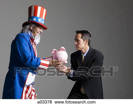 Stock Photo - Man in Uncle Sam's costume giving piggybank to other man, studio shot. Fotosearch