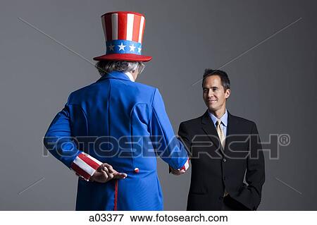 Stock Photo - Man in Uncle Sam's costume greeting other man, studio shot. Fotosearch