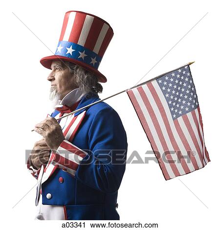 Man in Uncle Sam's costume holding american flag, studio shot View Large Photo Image Stock Image - Man in Uncle Sam's costume holding american flag, studio shot. Fotosearch