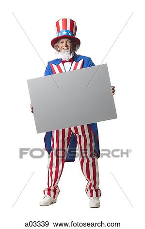 Man in Uncle Sam's costume holding blank paper, studio shot View Large Photo Image Stock Photo - Man in Uncle Sam's costume holding blank paper, studio shot. Fotosearch