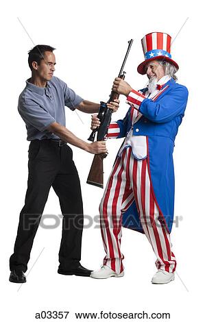 Man in Uncle Sam's costume seizing gun from other man, studio shot View Large Photo Image Stock Photo - Man in Uncle Sam's costume seizing gun from other man, studio shot. Fotosearch