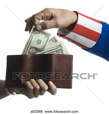 Stock Photo - Man in Uncle Sam's costume taking money from wallet, studio shot. Fotosearch