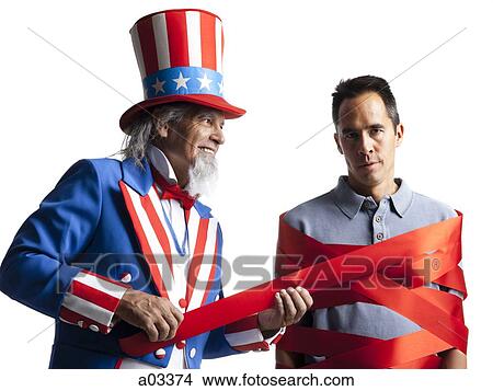 Man in Uncle Sam's costume wrapping other man with ribbon, studio shot View Large Photo Image Picture - Man in Uncle Sam's costume wrapping other man with ribbon, studio shot. Fotosearch
