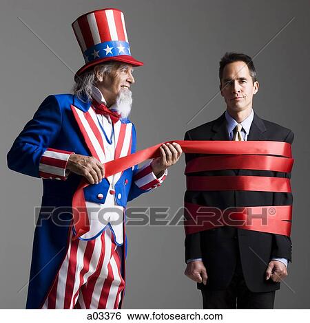Man in Uncle Sam's costume wrapping other man with ribbon, studio shot View Large Photo Image Stock Photograph - Man in Uncle Sam's costume wrapping other man with ribbon, studio shot. Fotosearch