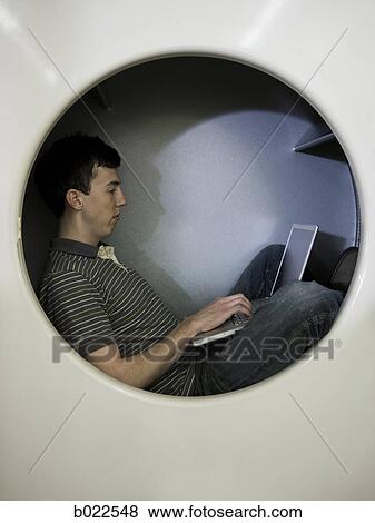 man inside a commercial clothes dryer at a laundromat View Large Photo Image Stock Photo - man inside a commercial clothes dryer at a laundromat. Fotosearch