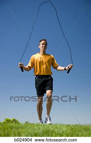 Picture - man jumping rope. Fotosearch