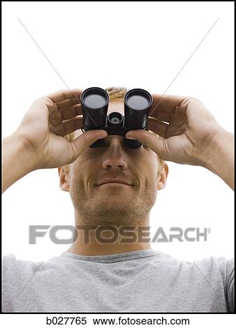 man looking through binoculars View Large Photo Image Stock Photography - man looking through binoculars. Fotosearch