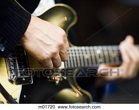 Stock Image - man playing a guitar. Fotosearch