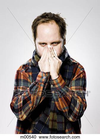man wearing flannel blosing his nose View Large Photo Image Stock Image - man wearing flannel blosing his nose. Fotosearch
