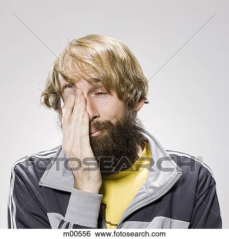 Stock Photograph - man with a beard wearing a track jacket. Fotosearch
