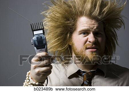 man with crazy hair holding hair clippers View Large Photo Image Stock Image - man with crazy hair holding hair clippers. Fotosearch