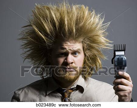 man with crazy hair holding hair clippers View Large Photo Image Stock Image - man with crazy hair holding hair clippers. Fotosearch