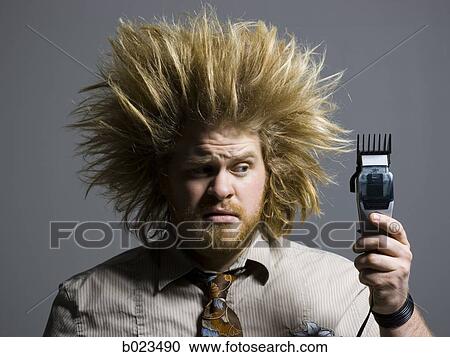 man with crazy hair holding hair clippers View Large Photo Image Stock Image - man with crazy hair holding hair clippers. Fotosearch