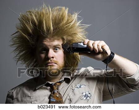 Stock Image - man with crazy hair holding hair clippers. Fotosearch