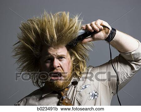 man with crazy hair holding hair clippers View Large Photo Image Stock Image - man with crazy hair holding hair clippers. Fotosearch