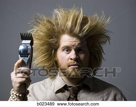 man with crazy hair holding hair clippers View Large Photo Image Stock Photo - man with crazy hair holding hair clippers. Fotosearch
