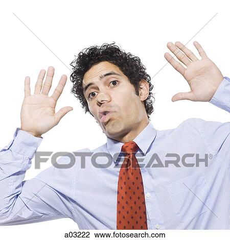 Stock Image - Man with face pressed up against window, studio shot. Fotosearch