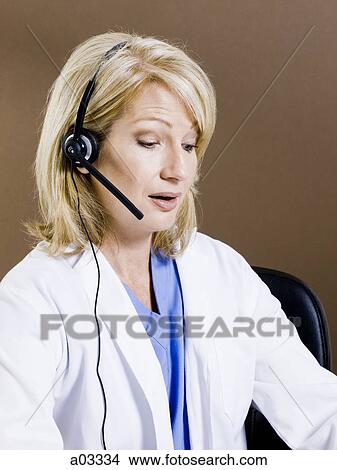 Mature woman talking on headset, studio shot View Large Photo Image Picture - Mature woman talking on headset, studio shot. Fotosearch