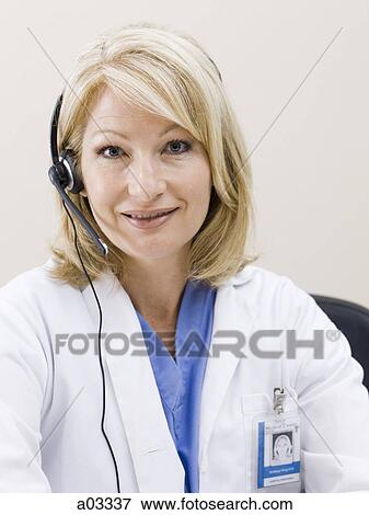 Mature woman talking on headset, studio shot View Large Photo Image Stock Photo - Mature woman talking on headset, studio shot. Fotosearch