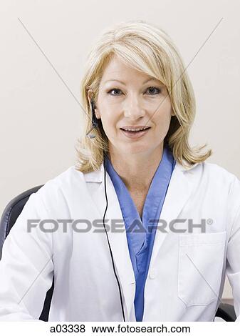 Mature woman talking on headset, studio shot View Large Photo Image Stock Photo - Mature woman talking on headset, studio shot. Fotosearch