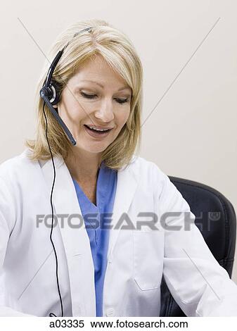 Mature woman talking on headset, studio shot View Large Photo Image Stock Photography - Mature woman talking on headset, studio shot. Fotosearch