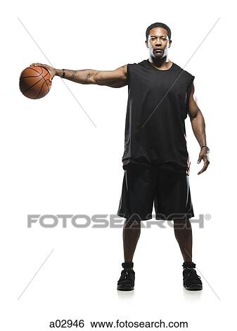 Mid adult man holding basketball in air, portrait View Large Photo Image Stock Photograph - Mid adult man holding basketball in air, portrait. Fotosearch