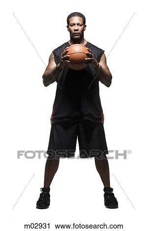 Mid adult man holding basketball View Large Photo Image Stock Image - Mid adult man holding basketball. Fotosearch