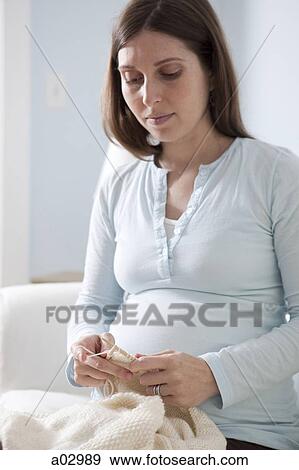 Mid adult pregnant woman knitting, mid section View Large Photo Image Stock Photo - Mid adult pregnant woman knitting, mid section . Fotosearch